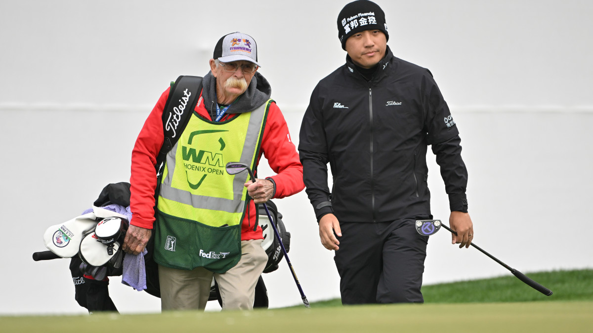 Mike “Fluff” Cowan caddies for C.T. Pan at the WM Phoenix Open.